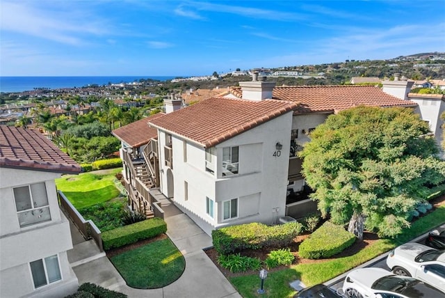 birds eye view of property with a water view