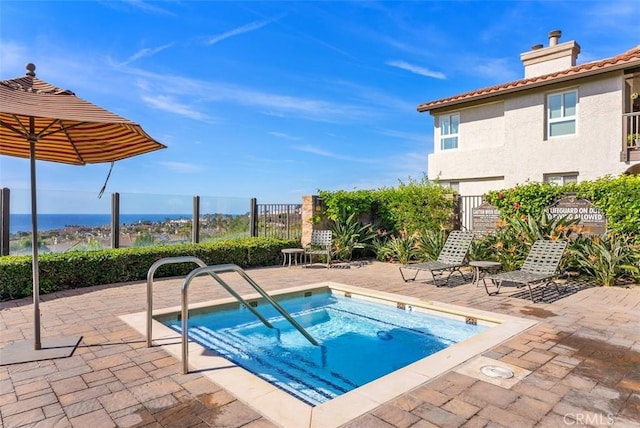 view of pool with a community hot tub and a patio area