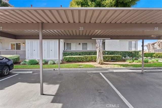 view of parking / parking lot featuring a carport