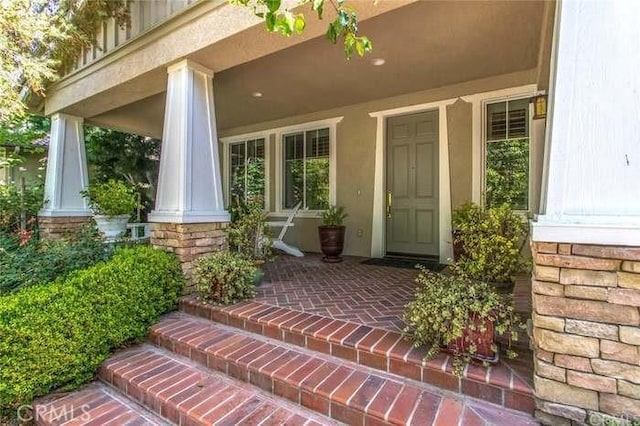 doorway to property featuring covered porch