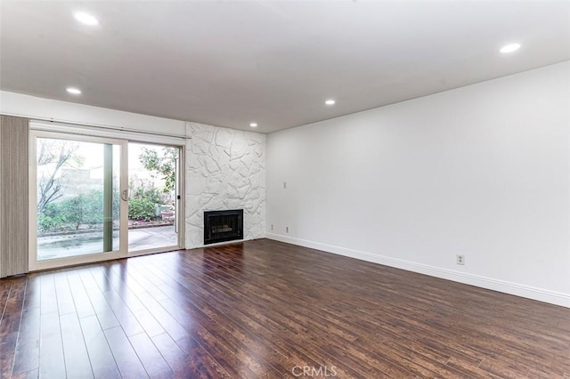 unfurnished living room with dark hardwood / wood-style floors and a premium fireplace