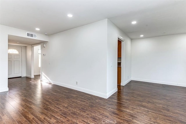 spare room featuring dark hardwood / wood-style flooring