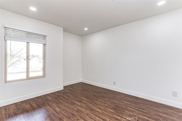 unfurnished room with dark hardwood / wood-style floors