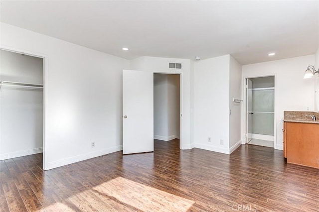 unfurnished bedroom featuring dark hardwood / wood-style flooring