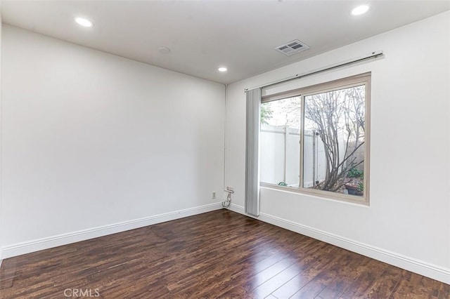 empty room with dark hardwood / wood-style flooring