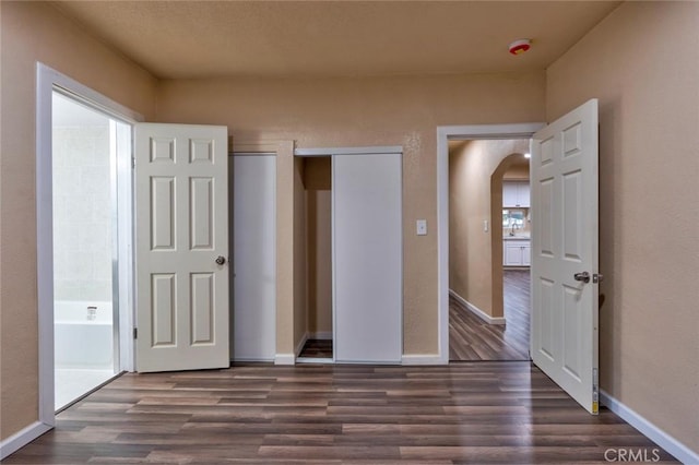 unfurnished bedroom featuring dark hardwood / wood-style floors