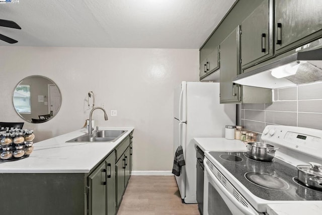 kitchen featuring ceiling fan, sink, tasteful backsplash, light hardwood / wood-style flooring, and range with electric stovetop