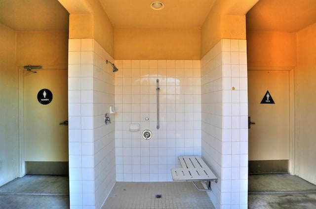 bathroom featuring a tile shower and concrete flooring