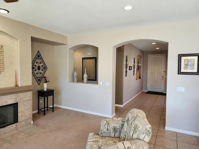 interior space with a tile fireplace