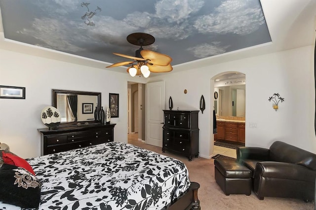 carpeted bedroom featuring ceiling fan and connected bathroom