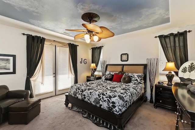 carpeted bedroom with ceiling fan and access to outside