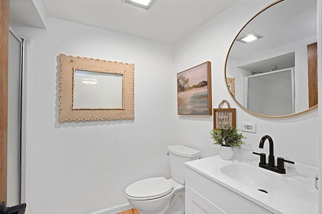 bathroom featuring vanity, toilet, and a shower with shower door