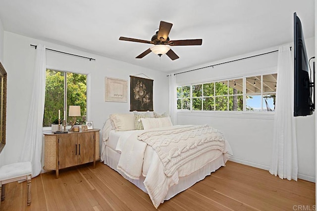 bedroom with ceiling fan and light hardwood / wood-style floors