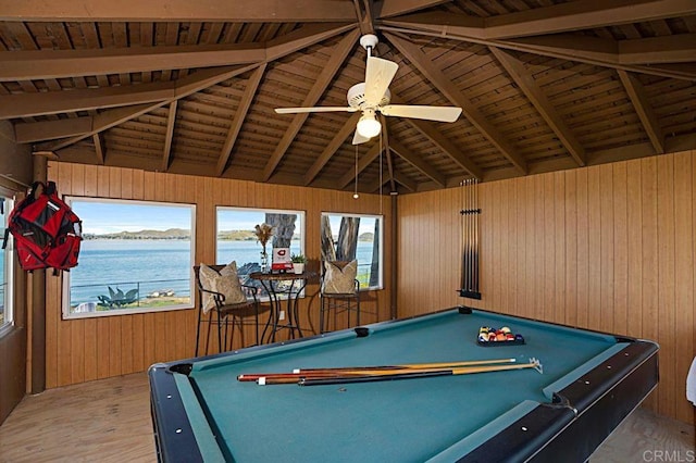 recreation room with wood walls, hardwood / wood-style floors, a water view, and billiards