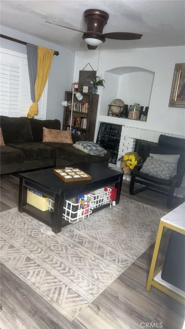 living room with ceiling fan and hardwood / wood-style flooring