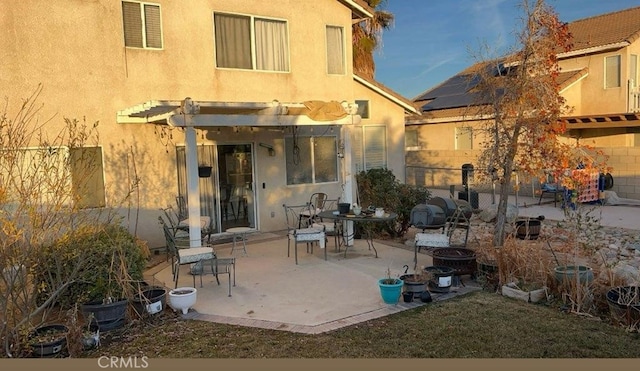 back of house with a pergola and a patio area