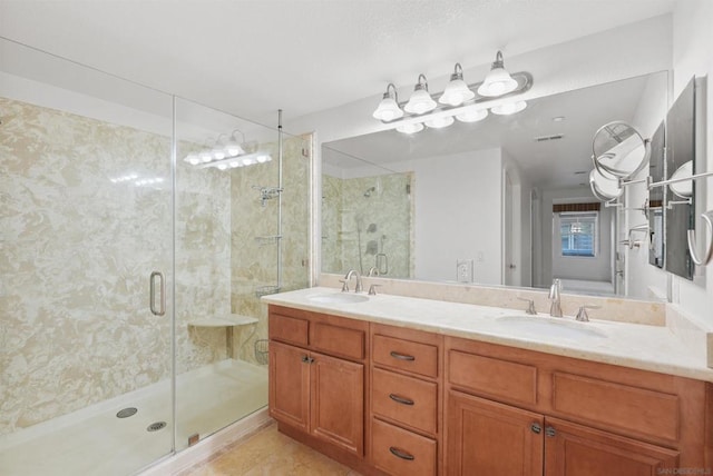 bathroom with vanity and a shower with shower door