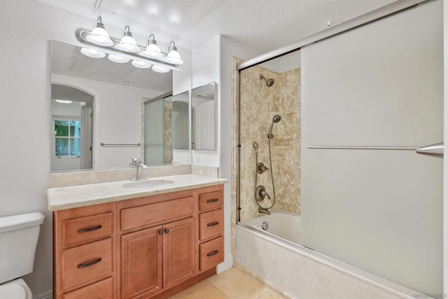 full bathroom with bath / shower combo with glass door, a textured ceiling, vanity, tile patterned flooring, and toilet