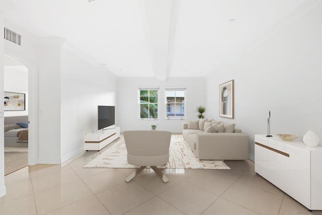 living room featuring beamed ceiling, light tile patterned floors, and ornamental molding