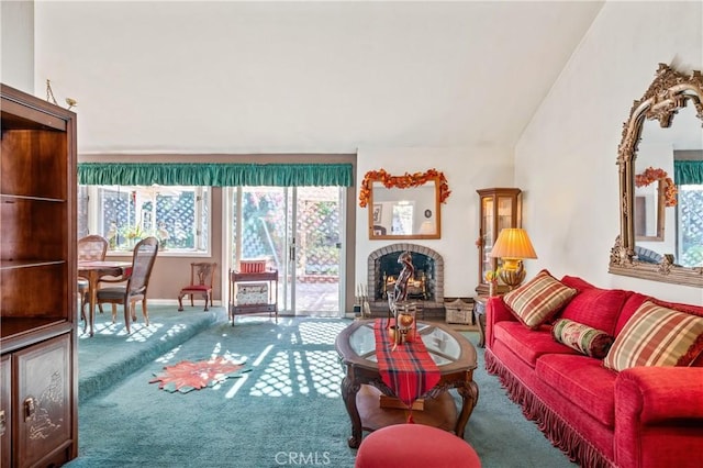 carpeted living room with a brick fireplace and vaulted ceiling