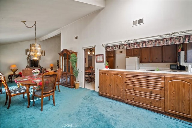 dining area with light colored carpet, a towering ceiling, and a chandelier