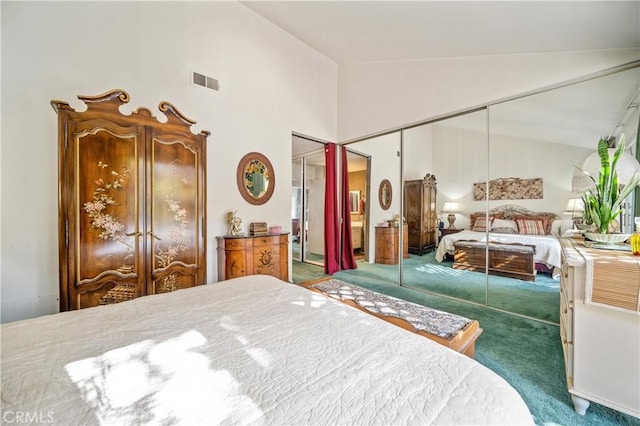 bedroom featuring a closet, carpet, and high vaulted ceiling