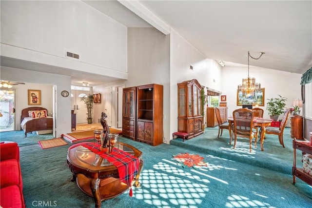 living room featuring ceiling fan with notable chandelier, carpet floors, and high vaulted ceiling