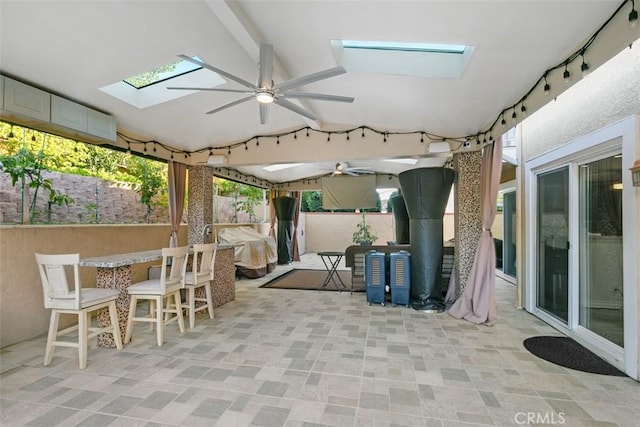 view of patio / terrace with an outdoor bar and ceiling fan