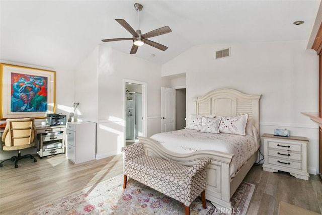 bedroom featuring lofted ceiling, ensuite bathroom, ceiling fan, and light hardwood / wood-style flooring