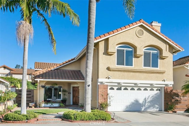 mediterranean / spanish house with a garage