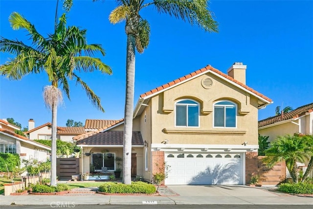 mediterranean / spanish home with a garage