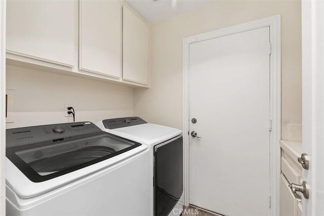 clothes washing area with independent washer and dryer and cabinets