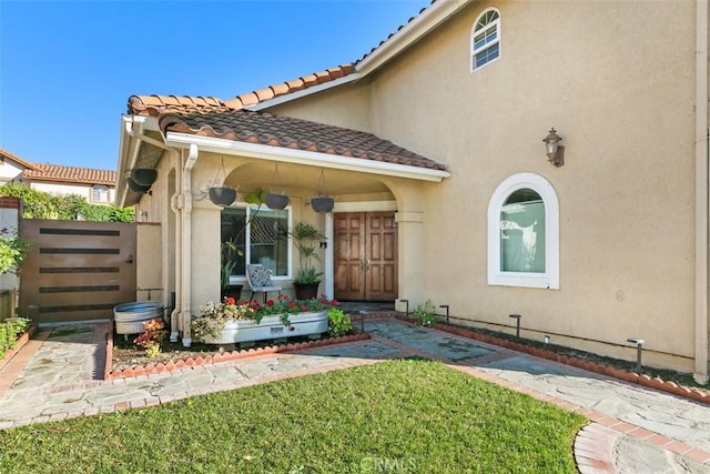 doorway to property with a yard