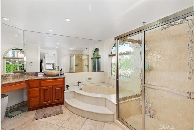 bathroom featuring separate shower and tub, a wealth of natural light, and vanity