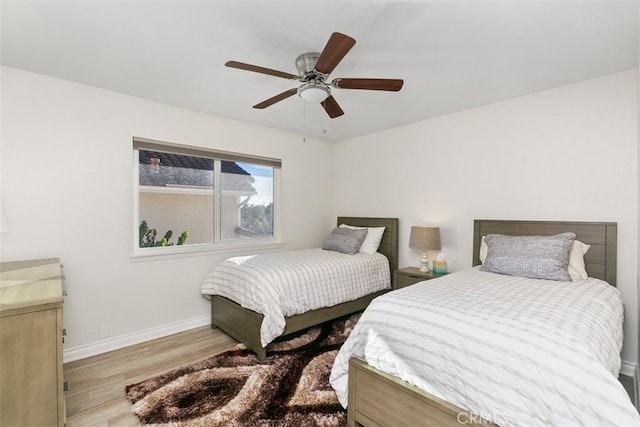 bedroom with ceiling fan and light hardwood / wood-style floors