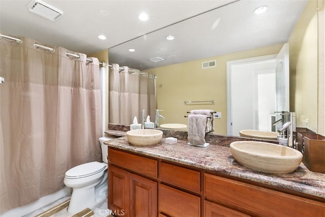 full bathroom featuring toilet, shower / bath combo with shower curtain, tile patterned flooring, and vanity