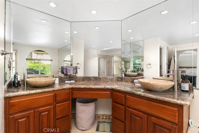 bathroom with an enclosed shower and vanity