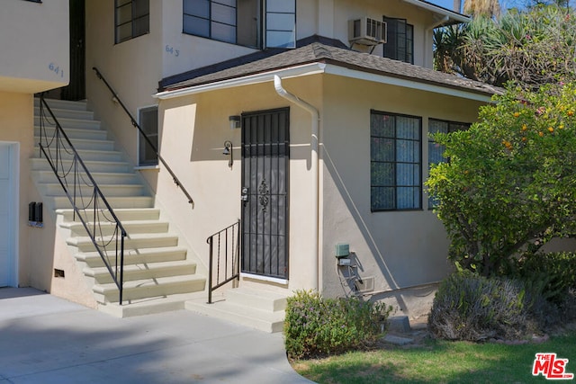 property entrance featuring an AC wall unit