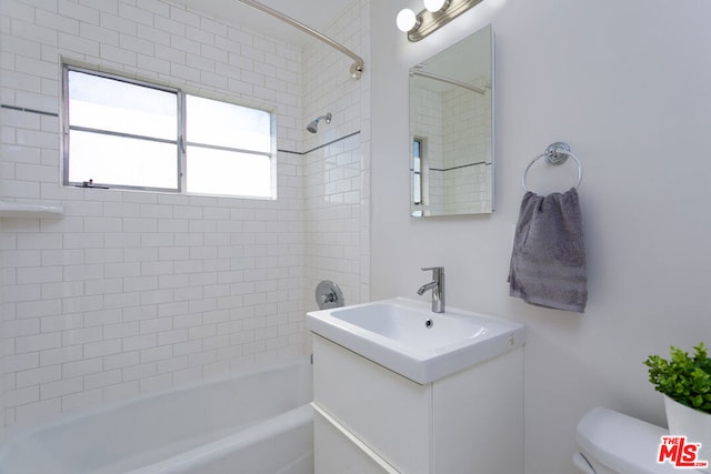 full bathroom featuring vanity, toilet, and tiled shower / bath