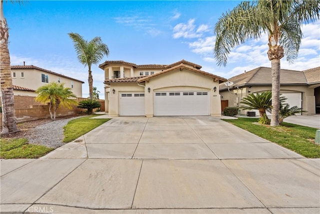 mediterranean / spanish home with a garage