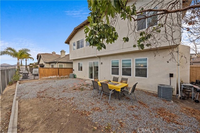 rear view of property with central AC unit