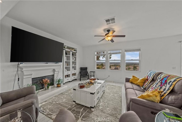 living room with ceiling fan and light hardwood / wood-style flooring