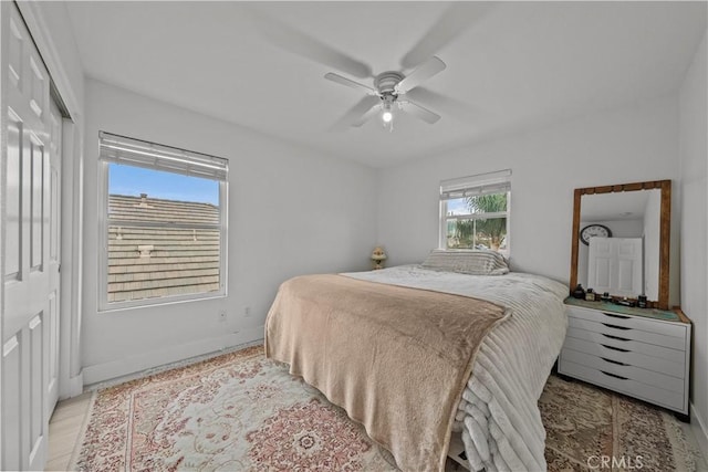 bedroom featuring ceiling fan and a closet