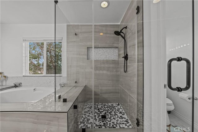 bathroom featuring toilet and an enclosed shower