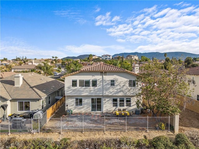 rear view of house featuring a mountain view