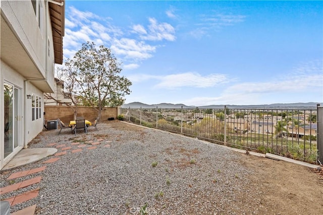 view of yard with a mountain view and a patio