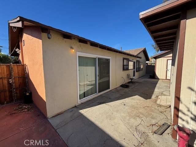 view of side of property with a patio