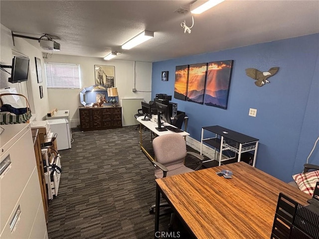 office with a textured ceiling and dark carpet