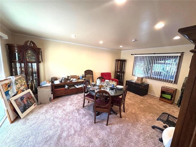 dining space featuring ornamental molding and light carpet