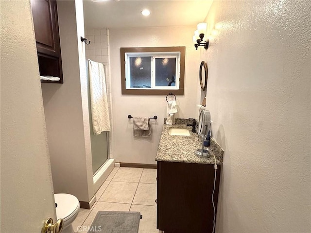 bathroom featuring an enclosed shower, vanity, tile patterned floors, and toilet